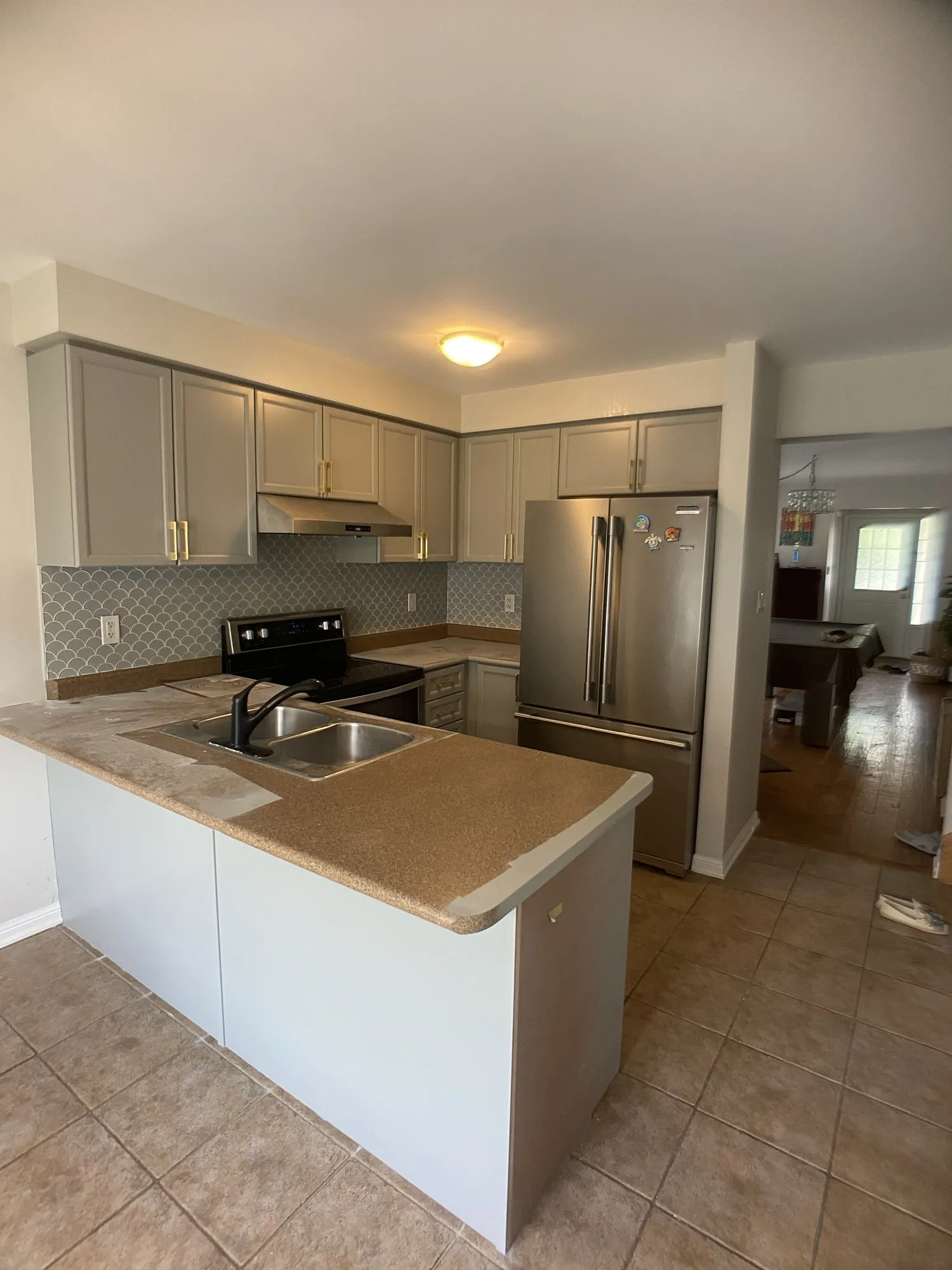 After — honey oak refinished light grey, counters and backsplash kept in West Oak Trails, Oakville
