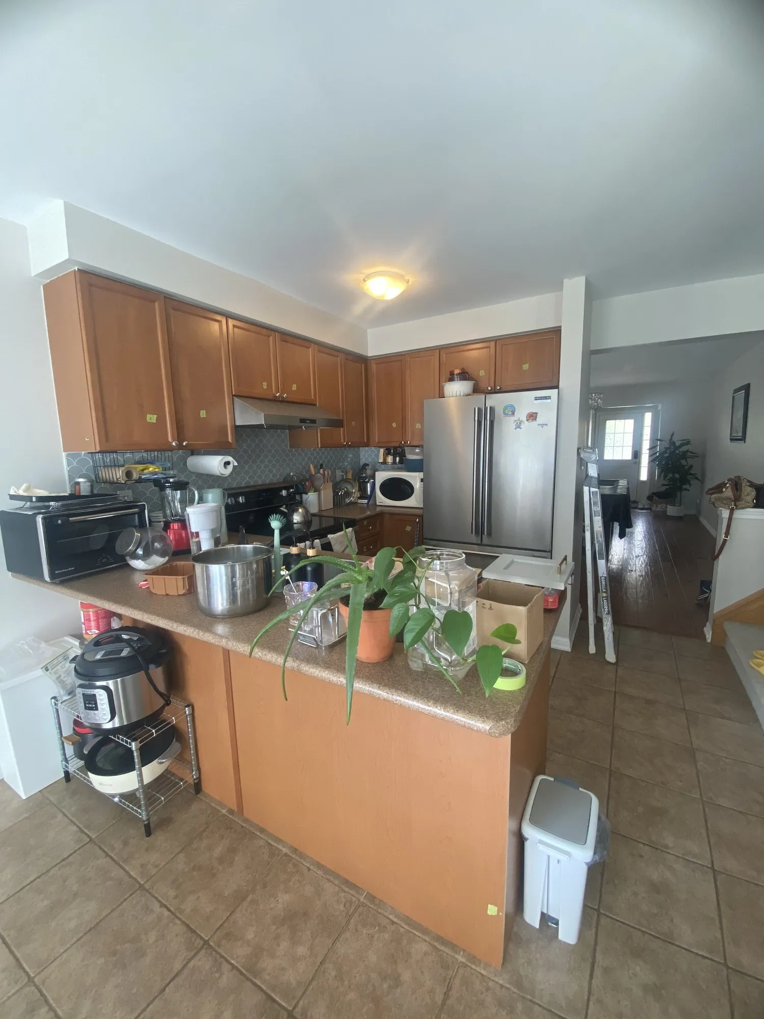 Before — honey oak refinished light grey, counters and backsplash kept in West Oak Trails, Oakville