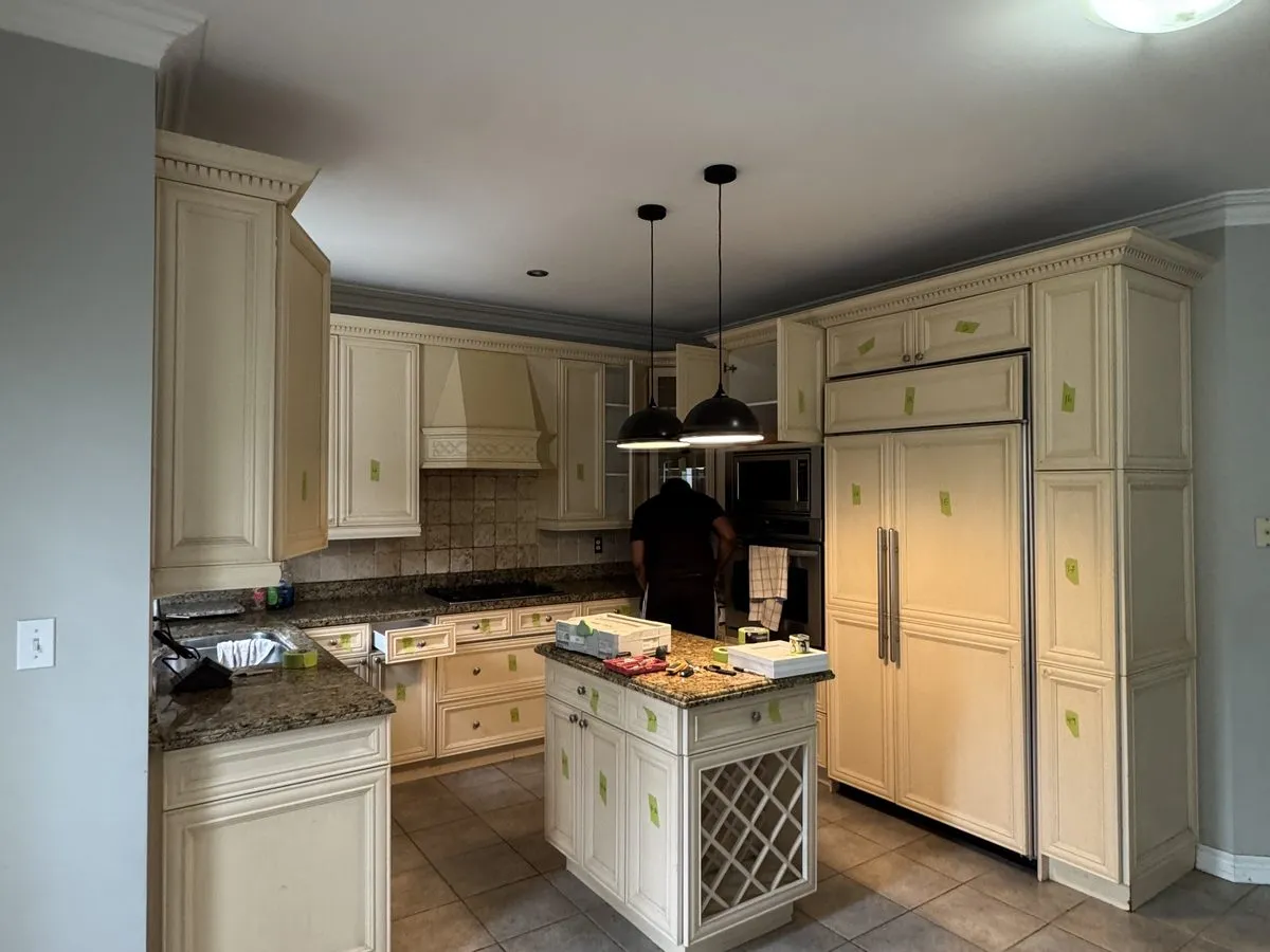 A kitchen island mid-upgrade, cabinets tagged for the work ahead, the lattice wine rack kept