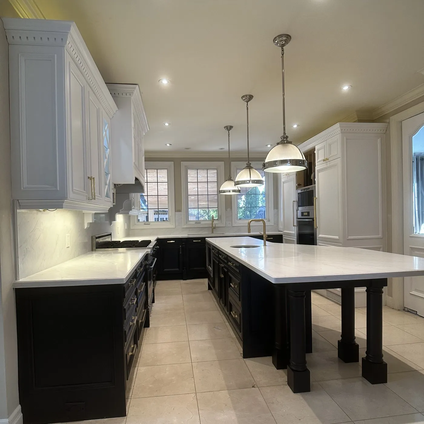 After — Quartz countertop replacement in Ford, Oakville — dark granite replaced with white quartz, the cabinets sprayed white over black in the same project