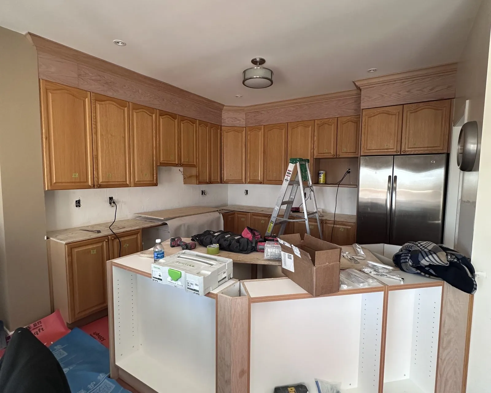 Before — counters off, island rebuilt, quartz through and a lighter floor — Glen Oaks, Oakville