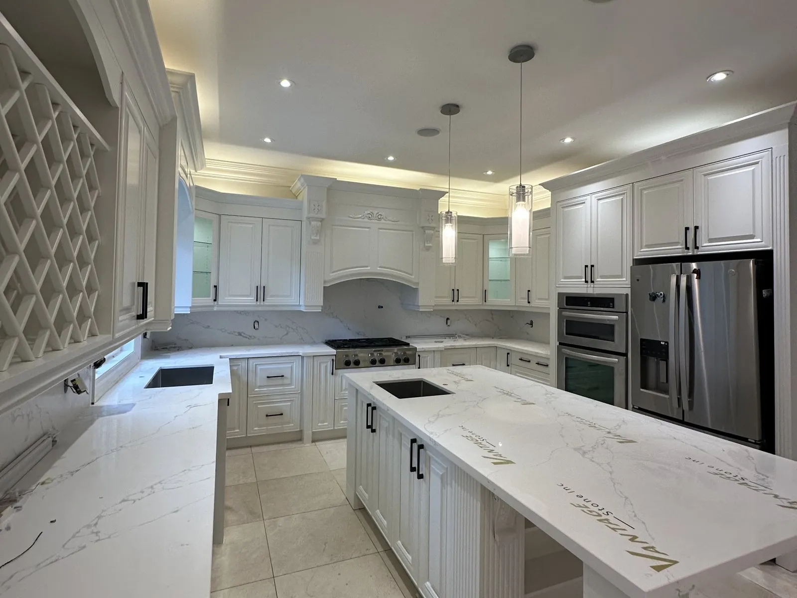 A finished quartz island in an Oakville kitchen, the veining running across the top and down the waterfall end