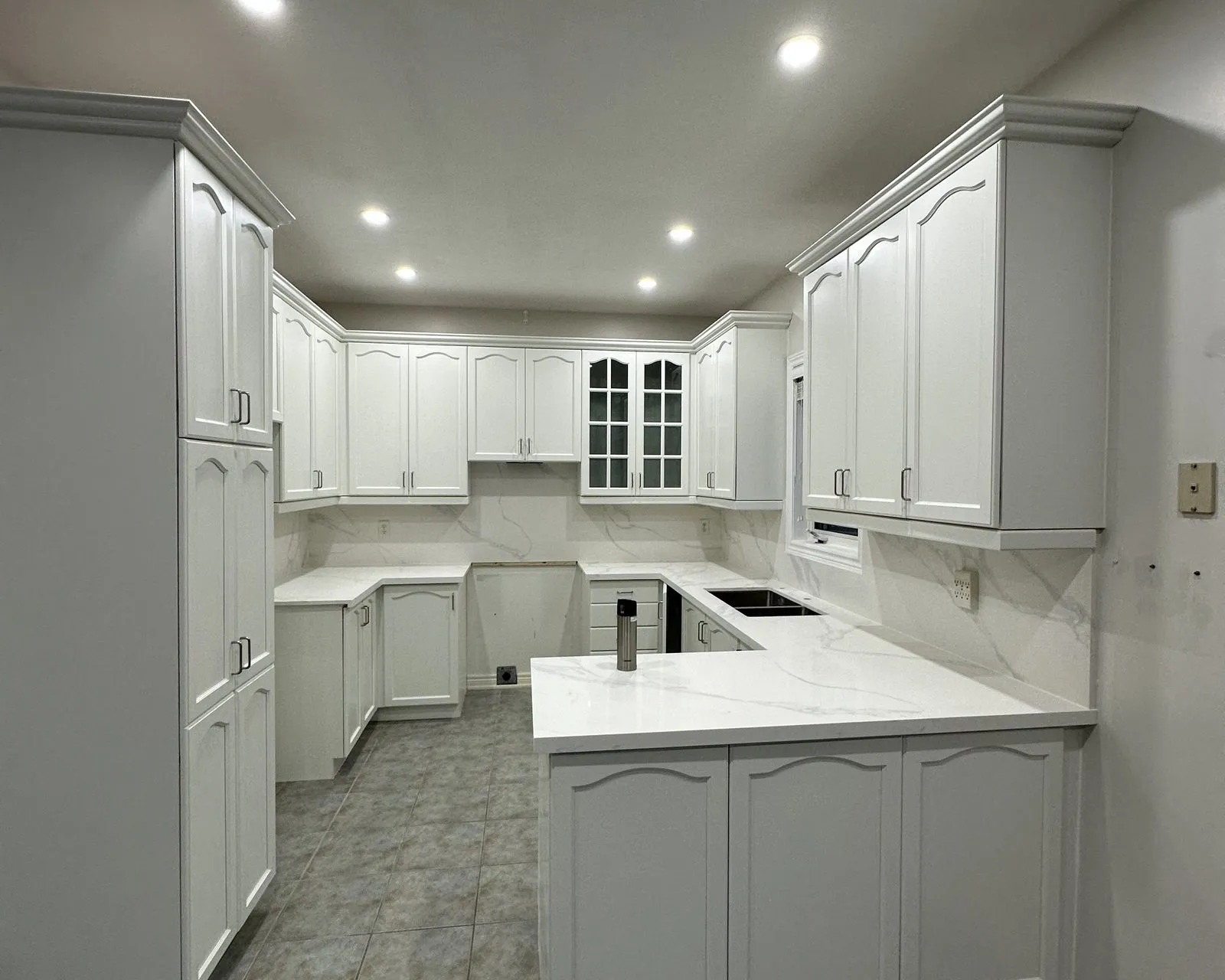 After — Quartz countertop installation in The Preserve, Oakville — a cherry kitchen with dated tops templated and refitted with white quartz and a matching slab backsplash