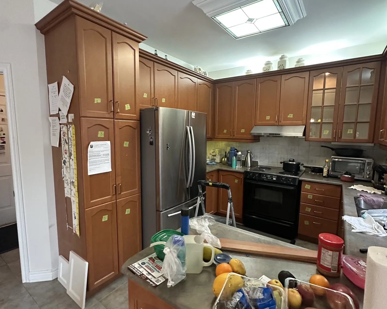 Before — Quartz countertop installation in The Preserve, Oakville — a cherry kitchen with dated tops templated and refitted with white quartz and a matching slab backsplash