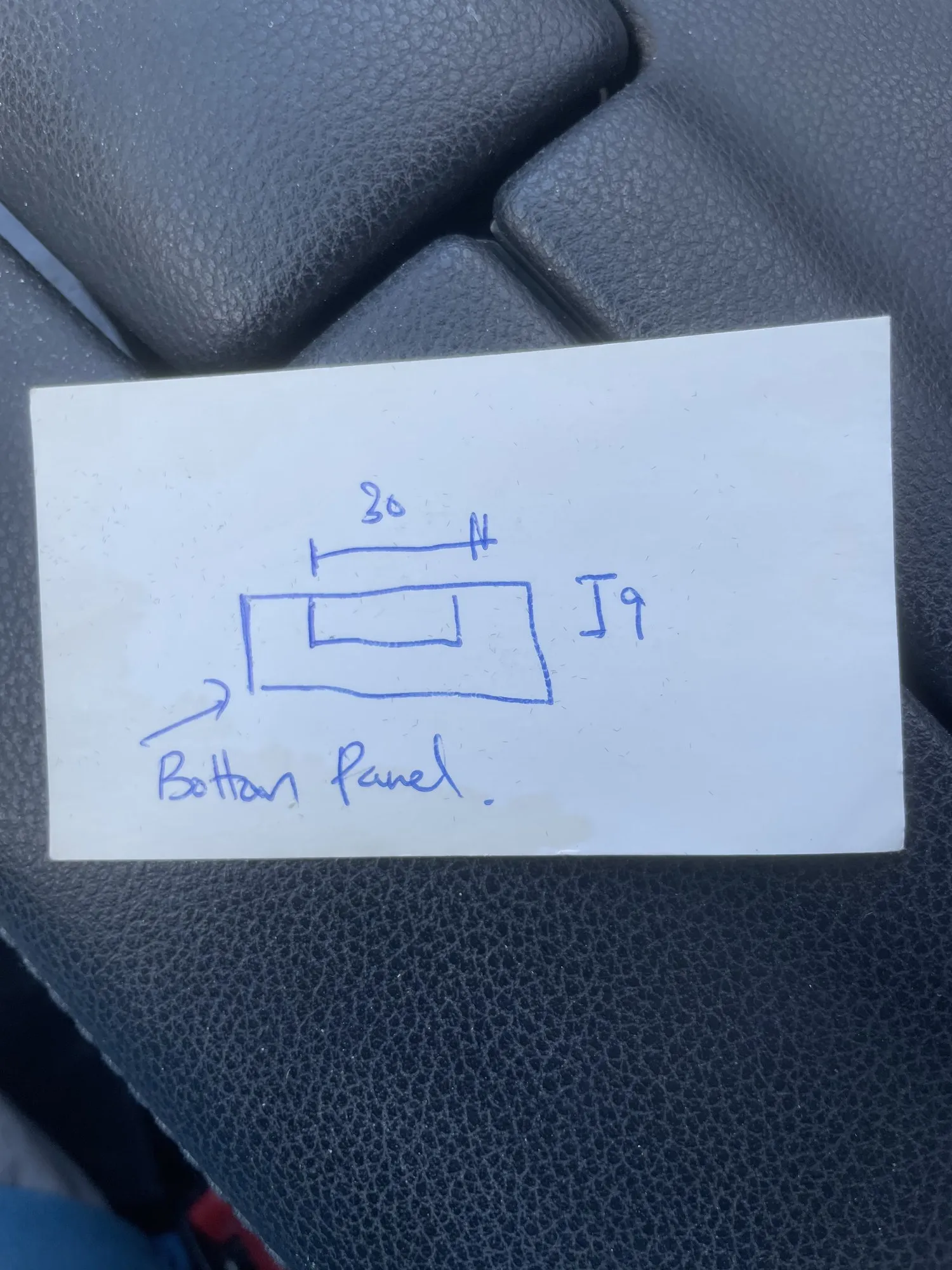 A small panel drawn on a scrap of paper resting on a car seat, marked thirty by nine and labelled bottom panel
